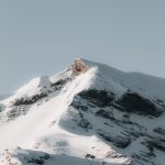 a snow covered mountain with a sky background