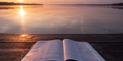 book on top of table and body of water